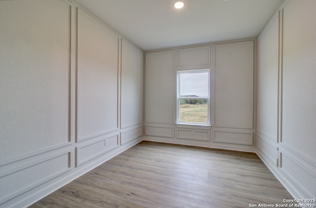 3625 Meteor Road New Braunfels, TX 78130 - Photo 20 of 39 an empty room with wooden floor and windows