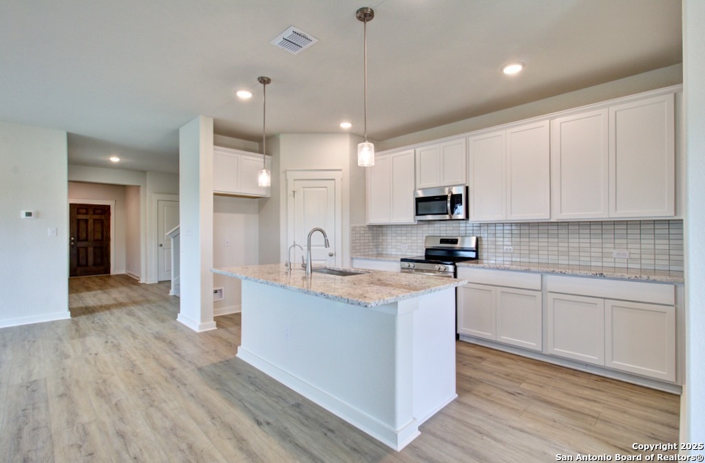 3625 Meteor Road New Braunfels, TX 78130 - Photo 2 of 39 a kitchen with stainless steel appliances granite countertop a sink stove and refrigerator
