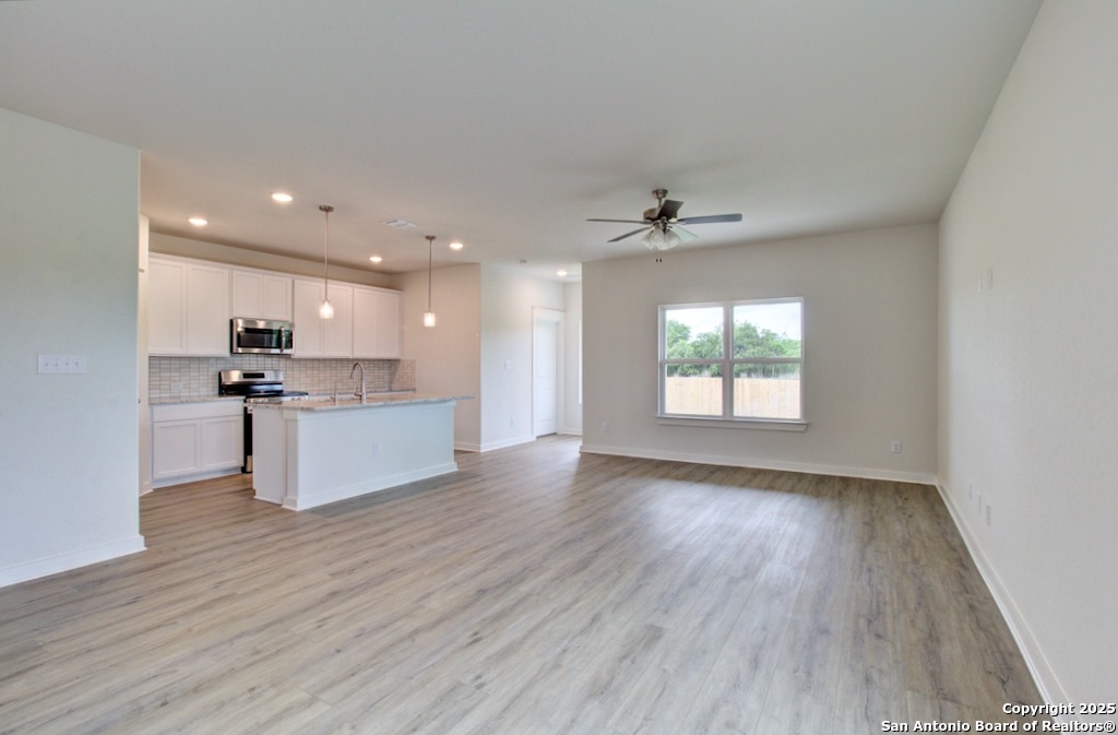 3625 Meteor Road New Braunfels, TX 78130 - Photo 5 of 39 a view of kitchen with granite countertop stainless steel appliances sink and wooden floor