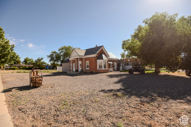 410 North Main Street Beaver, UT 84713 - Photo 2 of 31 View of home's exterior with brick siding and a metal roof
