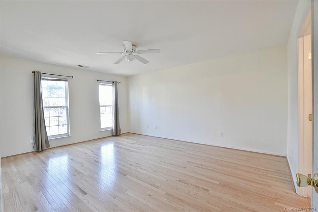 1021 Kilpatrick Lane Fort Mill, SC 29708 - Photo 20 of 34 an empty room with wooden floor ceiling fan and windows
