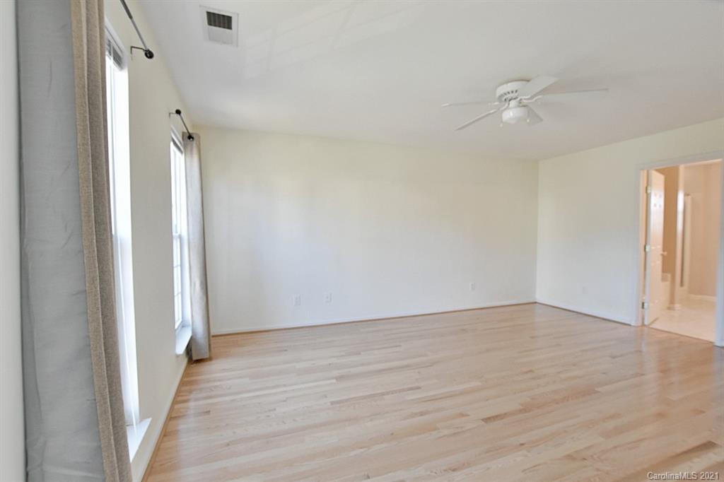 1021 Kilpatrick Lane Fort Mill, SC 29708 - Photo 21 of 34 wooden floor in an empty room with a window