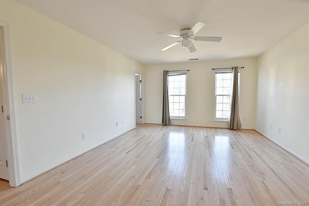 1021 Kilpatrick Lane Fort Mill, SC 29708 - Photo 22 of 34 an empty room with wooden floor fan and windows