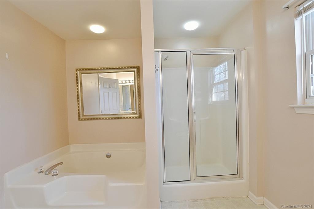 1021 Kilpatrick Lane Fort Mill, SC 29708 - Photo 24 of 34 a bathroom with a bathtub and a shower