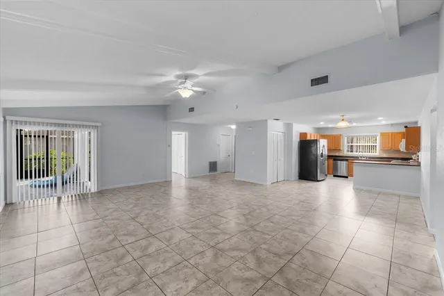 a kitchen with stainless steel appliances granite countertop a refrigerator a sink and a stove