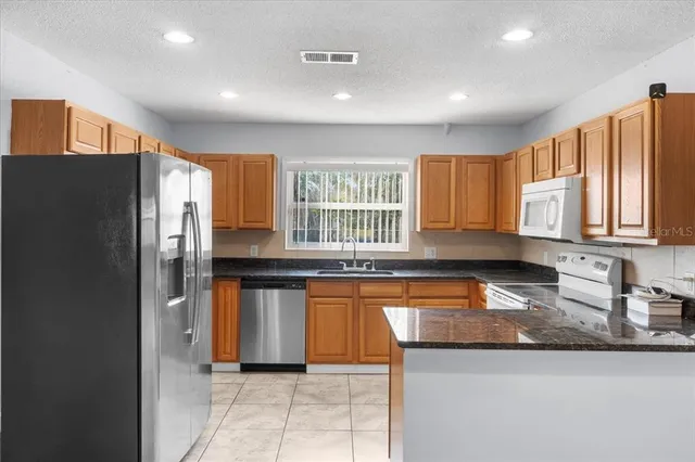 a view of an empty room with a ceiling fan