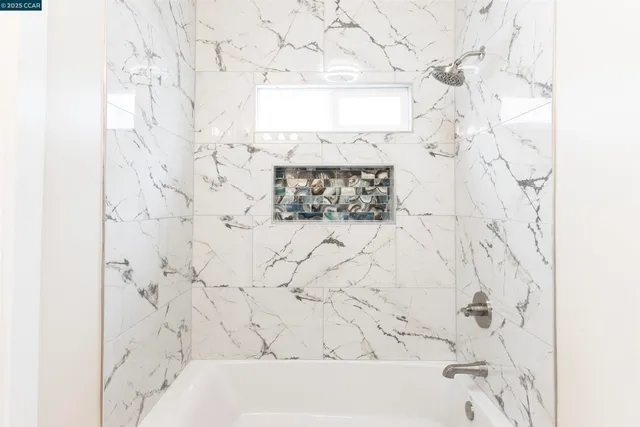 a bathroom with a bathtub and shower