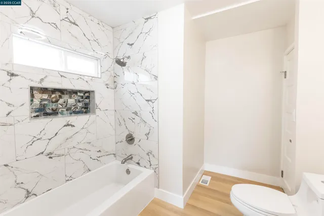 a bathroom with a bathtub and shower