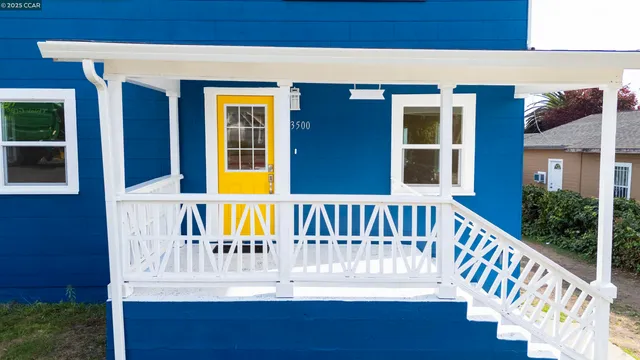 a view of a deck with a white house