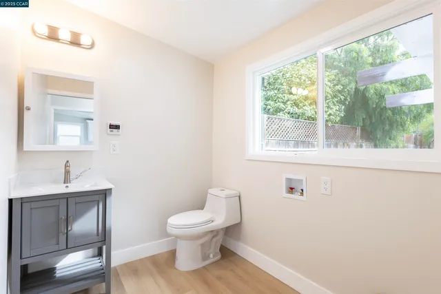 a white toilet sitting next to a bathroom sink