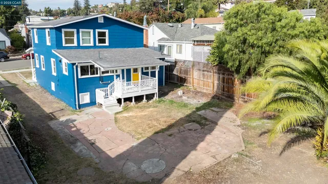 an aerial view of a house with a yard