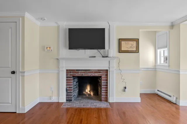a living room with a fireplace and a flat screen tv
