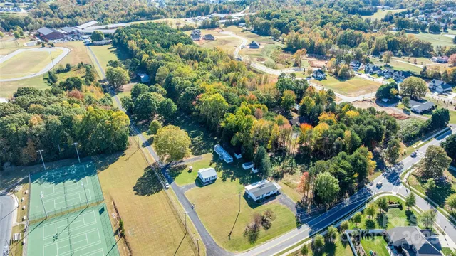 an aerial view of a house with yard swimming pool and outdoor seating