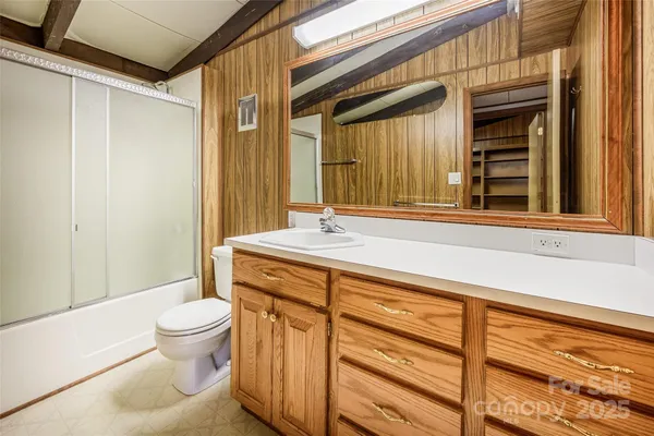 a bathroom with a sink a toilet and a shower