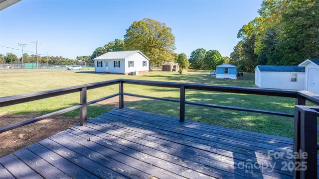 a view of house with deck and outdoor space