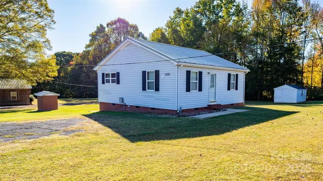 a view of a house with swimming pool and yard