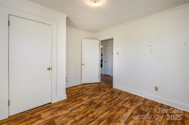 a view of a room with wooden floor