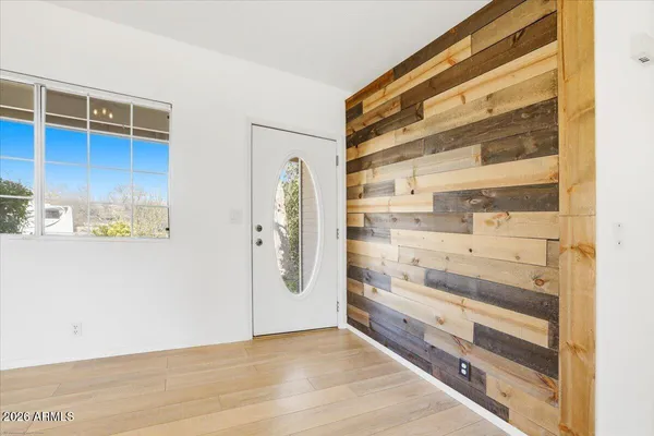 a view of an entryway with wooden floors