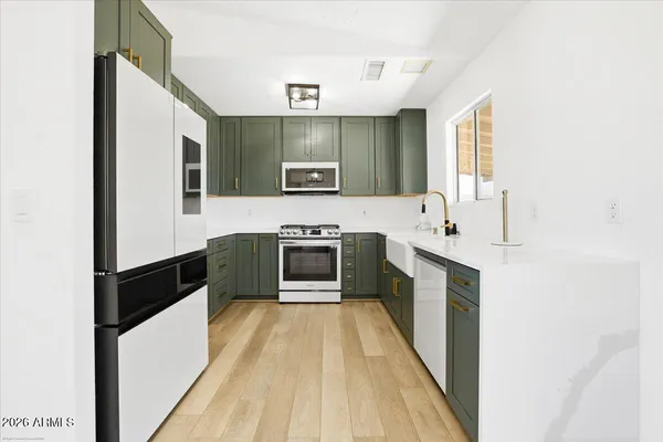 a spacious bathroom with a double vanity sink a mirror and a bathtub