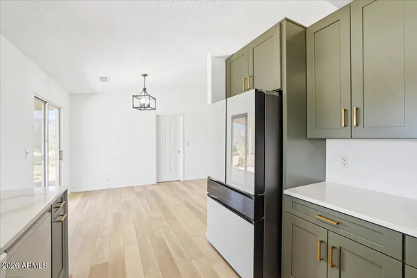 a kitchen with stainless steel appliances a refrigerator and a cabinets