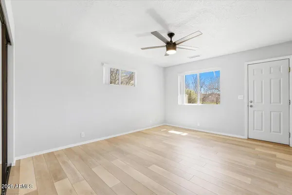 a view of empty room with wooden floor