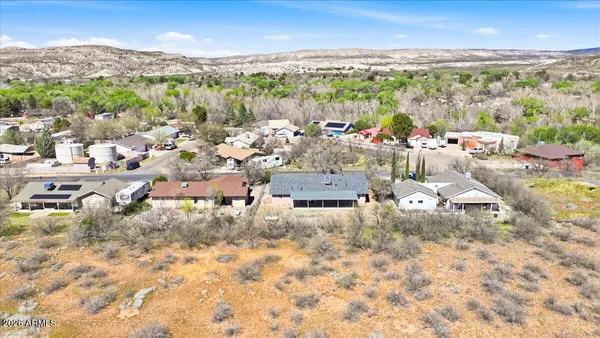 an aerial view of residential houses with outdoor space