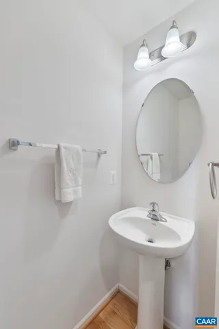 a bathroom with a sink a mirror and vanity