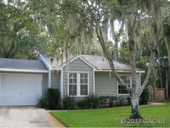 331 Northwest 50th Boulevard Gainesville, FL 32607 - Photo 1 of 1 a front view of a house with a yard and green space