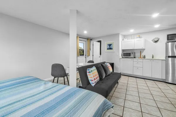 a spacious bedroom with a bed and furniture