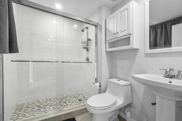 a bathroom with a sink toilet and shower