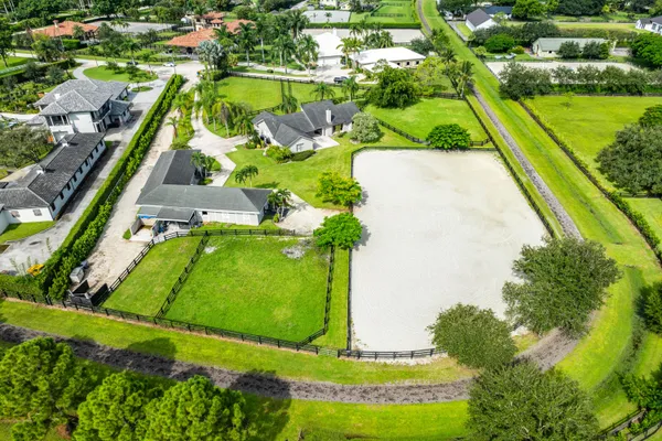 an aerial view of a residential houses with outdoor space and street view