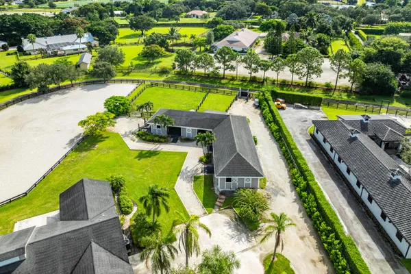 an aerial view of a house with a swimming pool patio and lake view