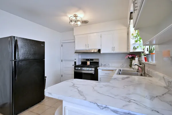 a kitchen with a refrigerator and a sink