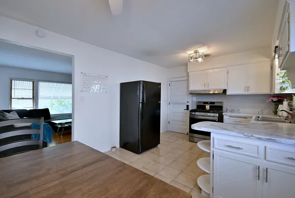 a kitchen with a refrigerator and a stove top oven