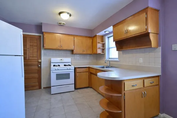 a kitchen with a sink cabinets and stainless steel appliances