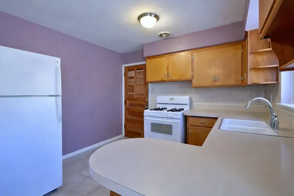 a kitchen with stainless steel appliances a sink stove and refrigerator