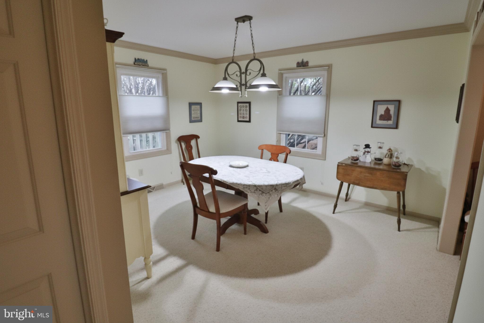 588 Crosswinds Drive Lititz, PA 17543 - Photo 27 of 38 a dining room with furniture a chandelier and wooden floor