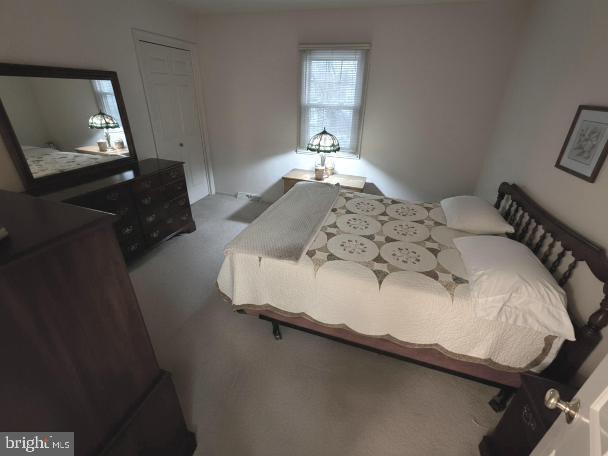 588 Crosswinds Drive Lititz, PA 17543 - Photo 28 of 38 a bedroom with a bed and a mirror on dresser