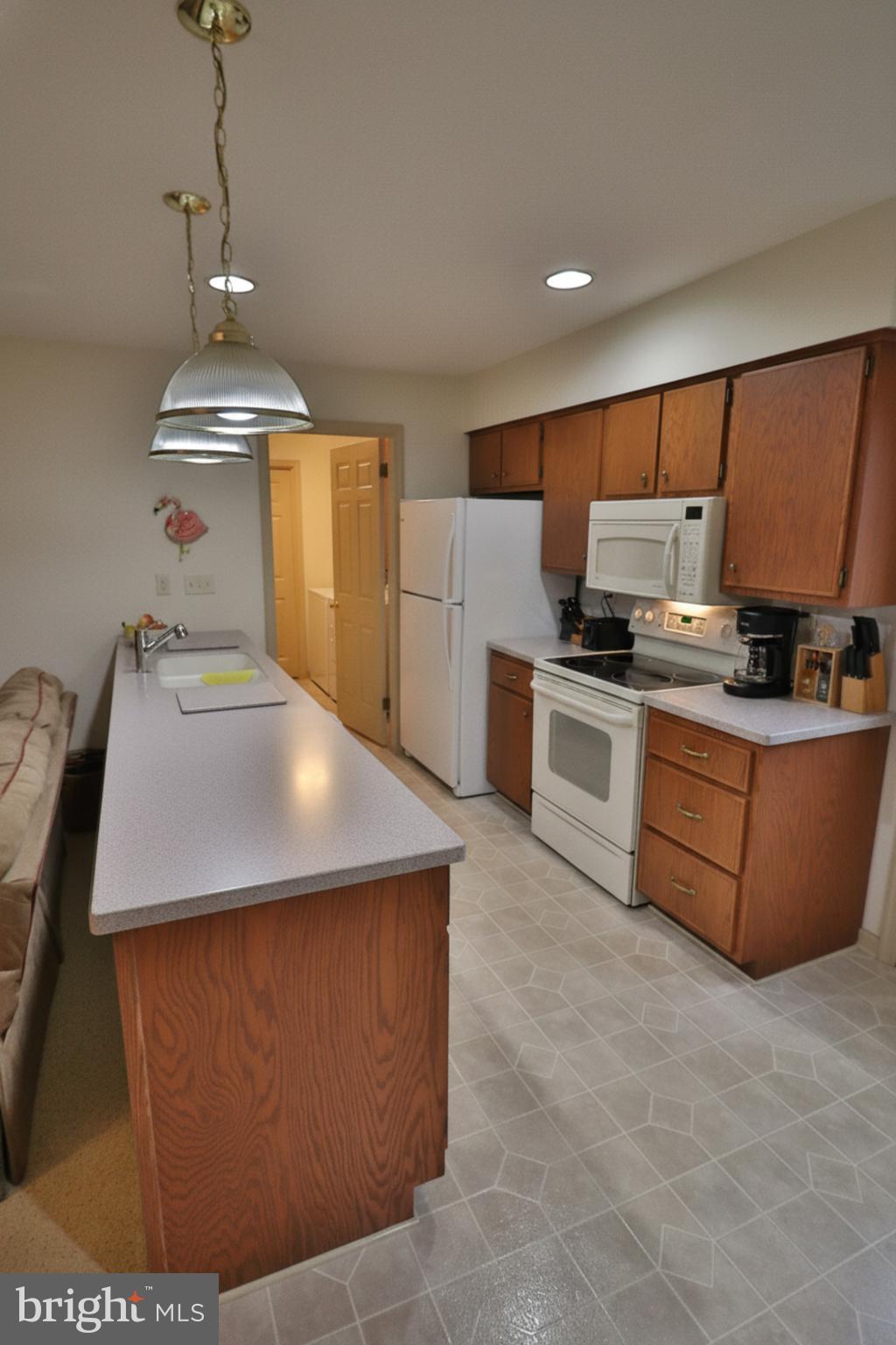 588 Crosswinds Drive Lititz, PA 17543 - Photo 7 of 38 a kitchen with stainless steel appliances a stove a refrigerator white cabinets and a refrigerator