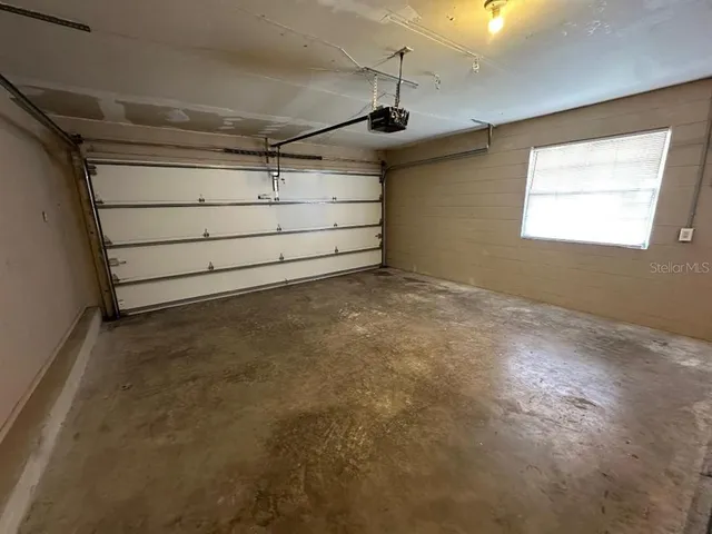 a view of a dirt yard with a large tree
