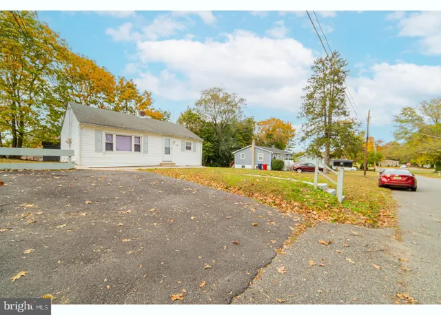 a view of a house with backyard and tree