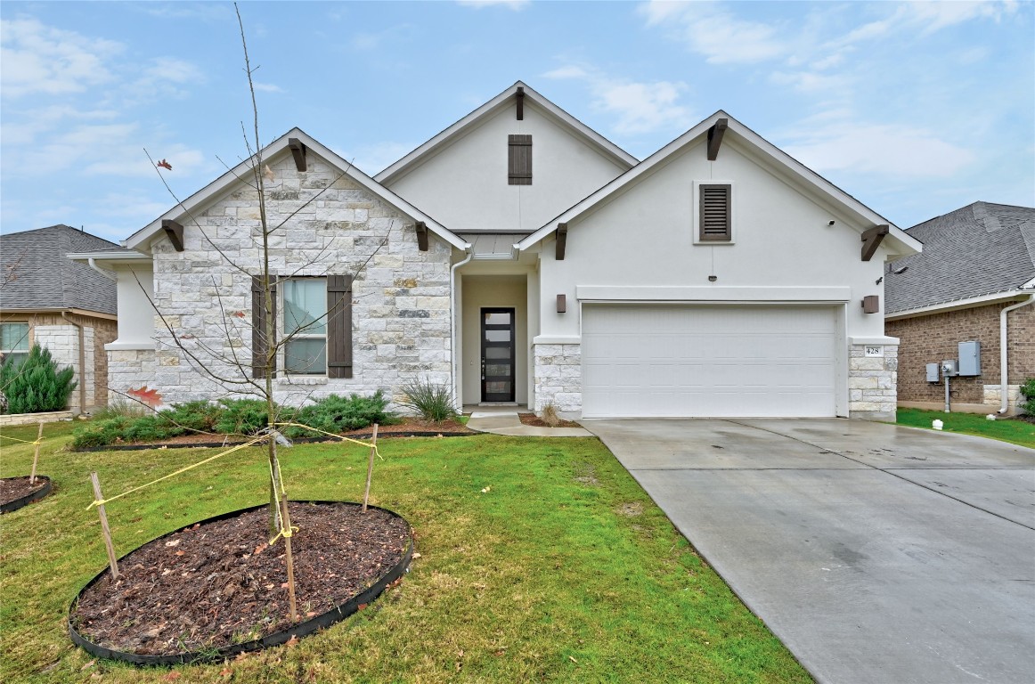 a view of a house with a yard and garage
