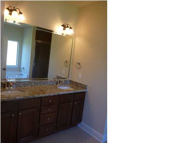 343 Whispering Lake Drive Santa Rosa Beach, FL 32459 - Photo 13 of 22 a bathroom with a granite countertop sink and a mirror