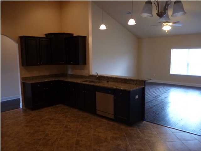 343 Whispering Lake Drive Santa Rosa Beach, FL 32459 - Photo 15 of 22 a living room with stainless steel appliances kitchen island granite countertop furniture and a fireplace