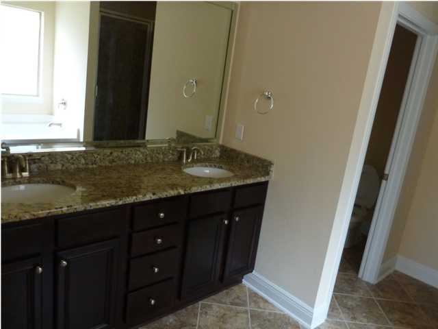 343 Whispering Lake Drive Santa Rosa Beach, FL 32459 - Photo 18 of 22 a bathroom with a granite countertop sink and a mirror