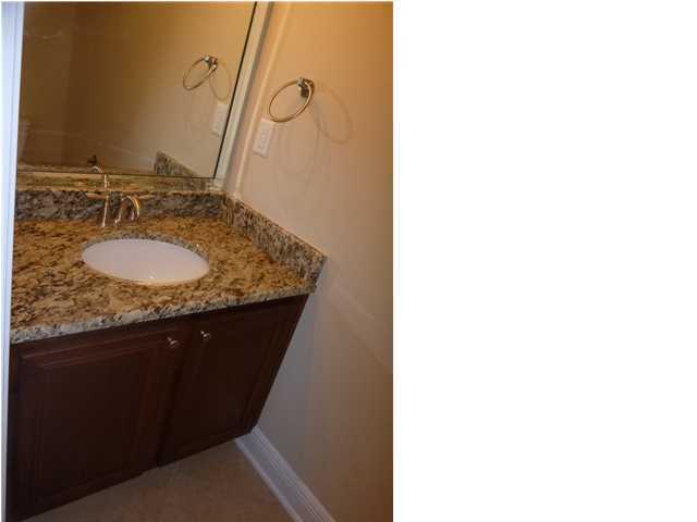 343 Whispering Lake Drive Santa Rosa Beach, FL 32459 - Photo 19 of 22 a bathroom with a granite countertop sink and a mirror