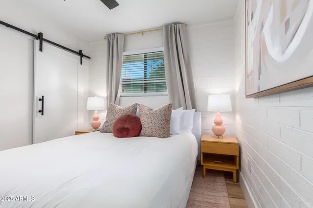 a bedroom with a bed and a window