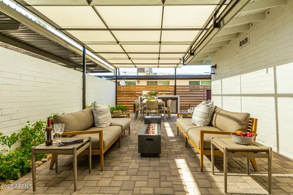 a patio with patio couch and potted plants