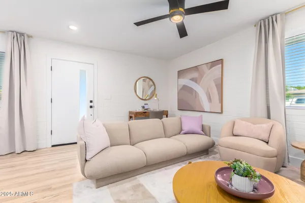 a living room with furniture and a wooden floor