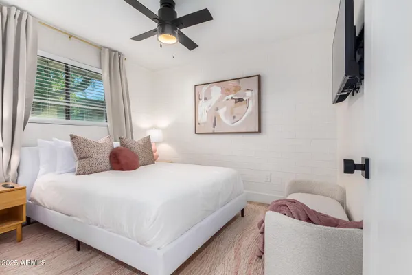 a bedroom with a bed and a window